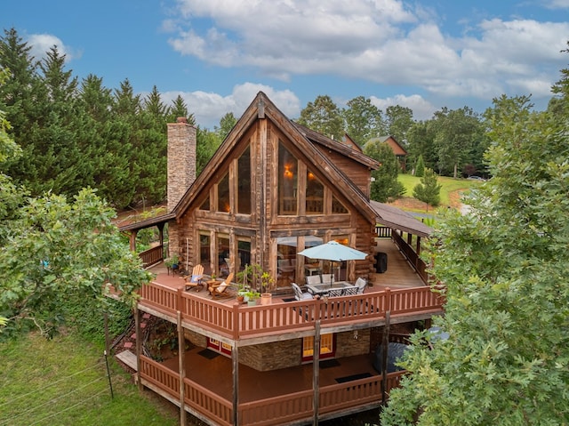 rear view of property with a wooden deck