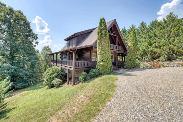 view of front facade with a deck and a front lawn