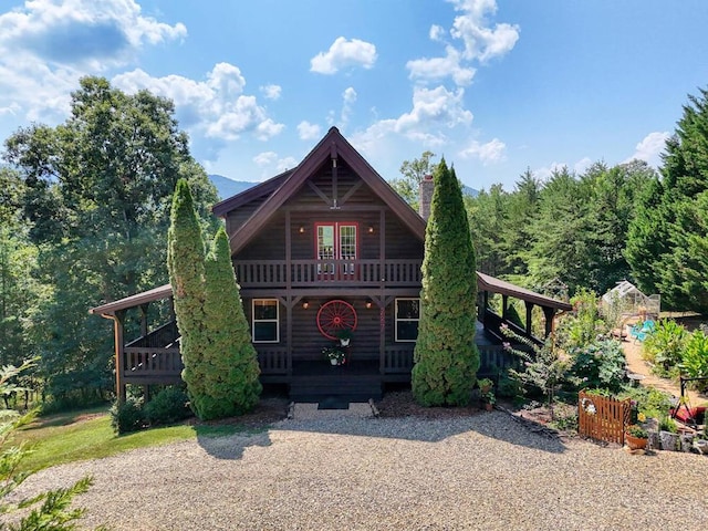 log-style house with a deck