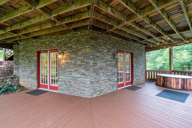 deck featuring a hot tub and french doors