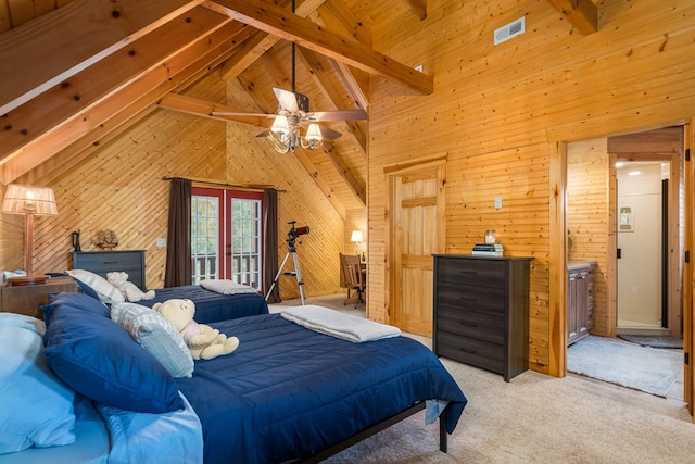 bedroom featuring light colored carpet, wooden walls, beam ceiling, and high vaulted ceiling