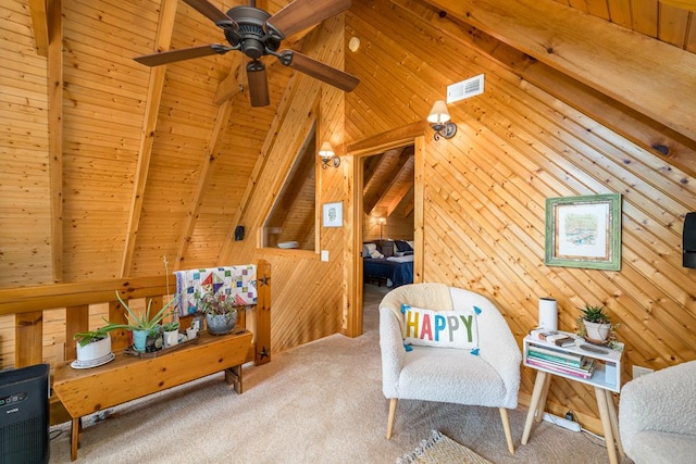 sitting room with vaulted ceiling with beams, wood ceiling, and wooden walls