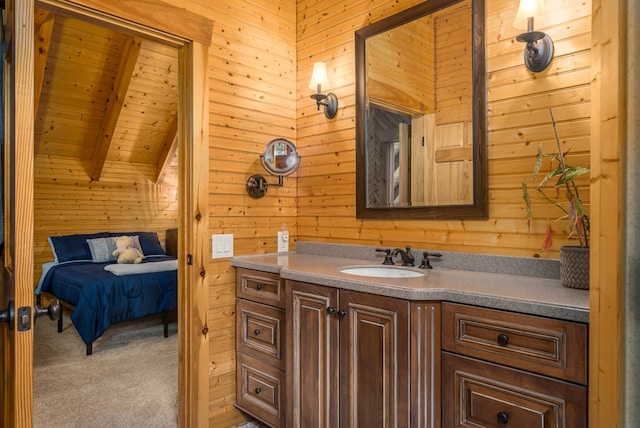 bathroom with vaulted ceiling with beams, vanity, wood ceiling, and wood walls