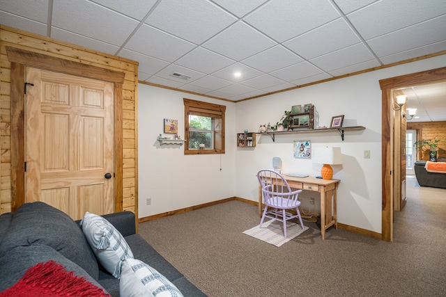 interior space with carpet floors, a drop ceiling, and crown molding