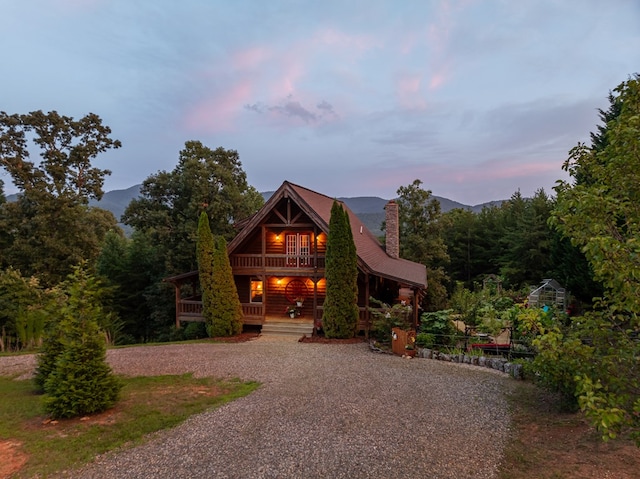 log home featuring a mountain view and covered porch