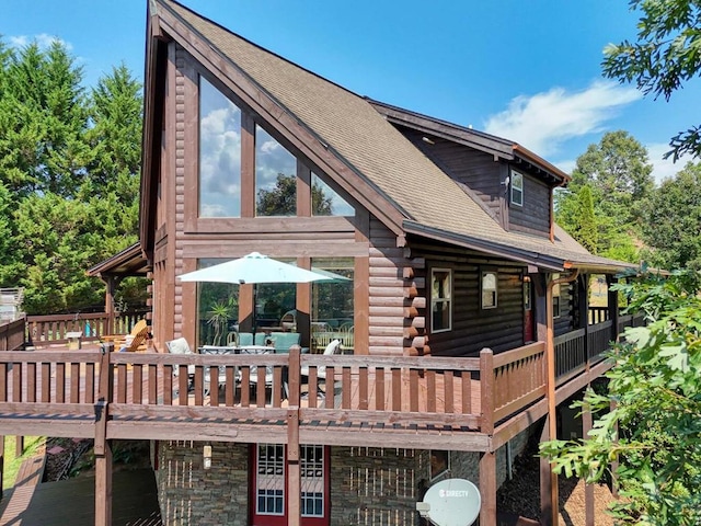 back of property featuring a wooden deck