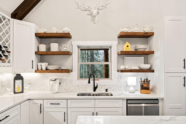 bar with light stone counters, dishwasher, sink, and white cabinets