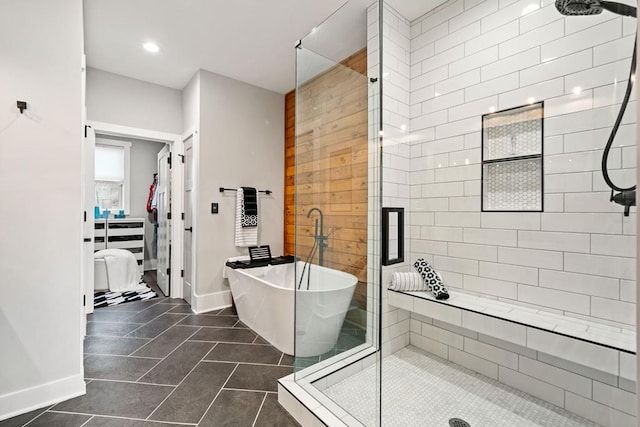 bathroom with shower with separate bathtub and tile patterned floors