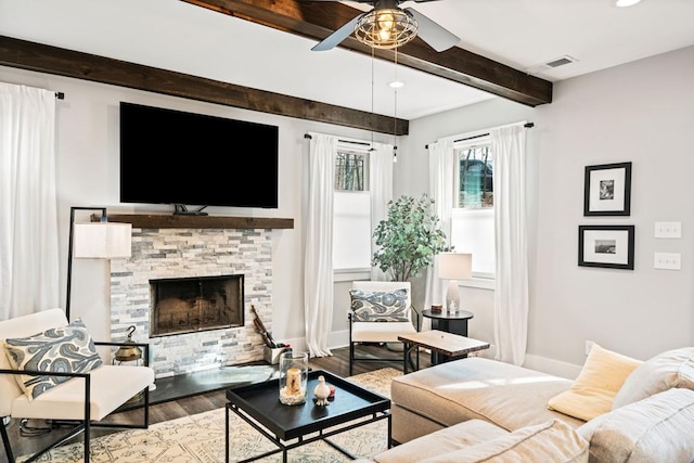 living room with beamed ceiling, ceiling fan, a fireplace, and hardwood / wood-style floors