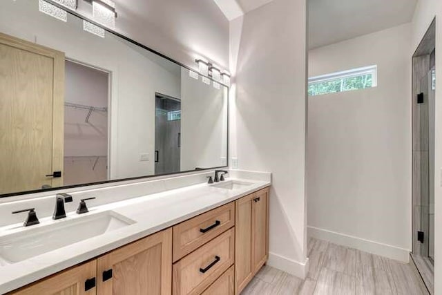 bathroom with vanity and an enclosed shower