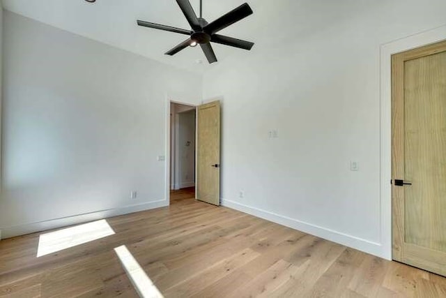 spare room featuring ceiling fan and light wood-type flooring