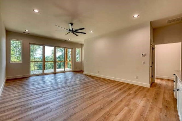 unfurnished living room with ceiling fan and light wood-type flooring