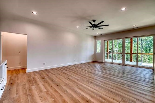 spare room with ceiling fan and light hardwood / wood-style floors