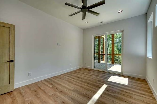 spare room featuring light hardwood / wood-style flooring and ceiling fan