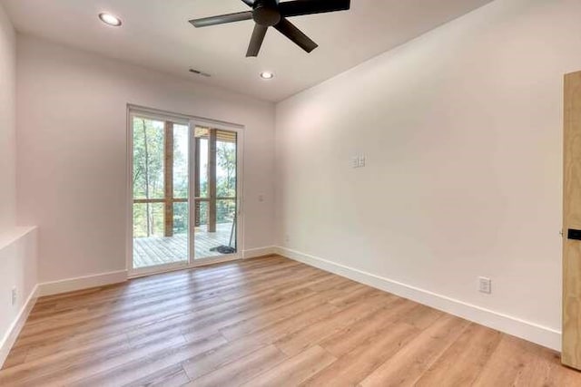 spare room featuring light hardwood / wood-style floors and ceiling fan