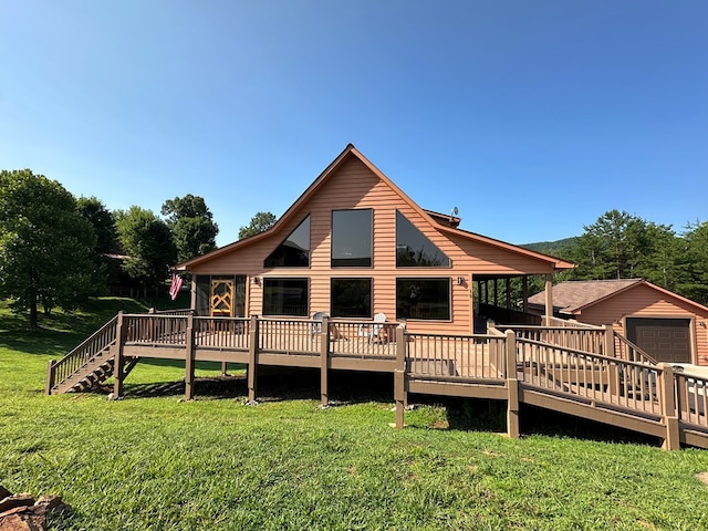 rear view of house featuring a wooden deck, an outbuilding, and a yard