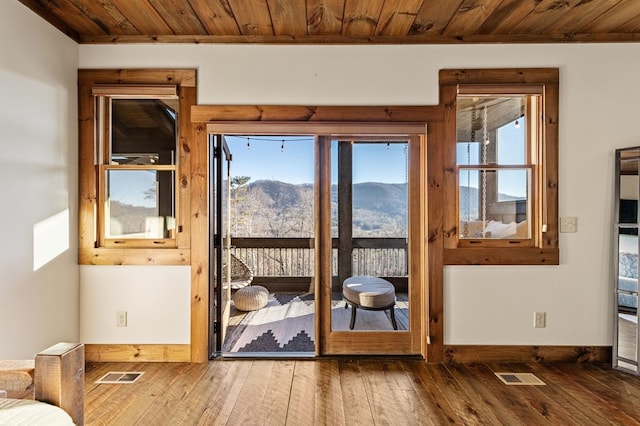 doorway to outside with wooden ceiling, a mountain view, and hardwood / wood-style flooring