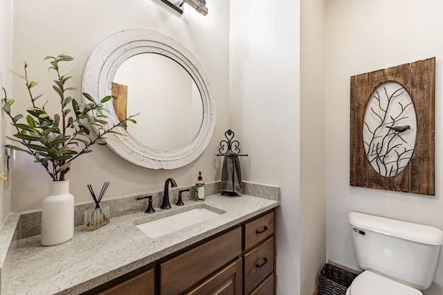 bathroom with toilet and vanity