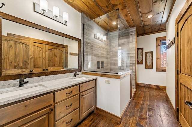 kitchen with dark hardwood / wood-style flooring, light stone counters, wood ceiling, and sink