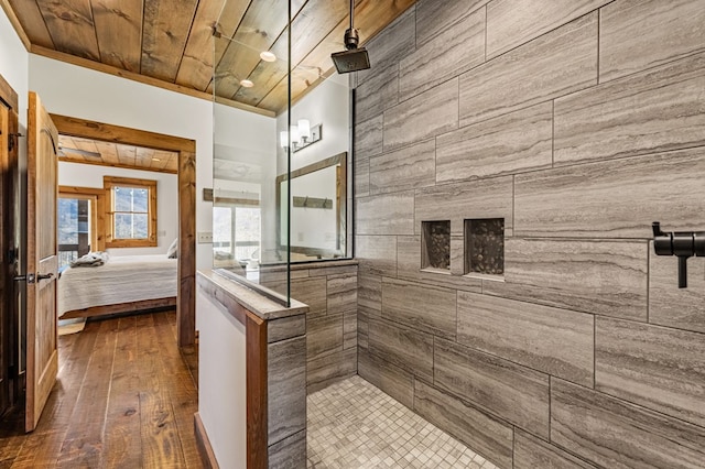 bathroom featuring wood ceiling, a tile shower, and wood-type flooring