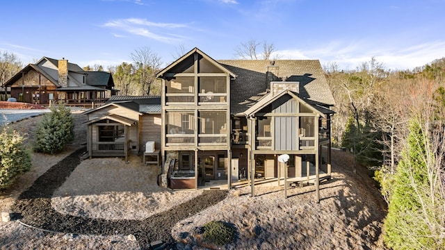 rear view of house with a patio and a sunroom