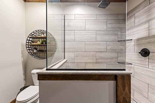 bathroom with toilet and tiled shower