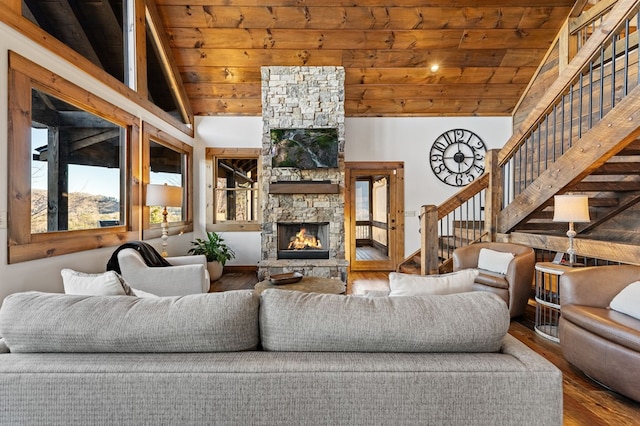 living room with a fireplace, hardwood / wood-style flooring, wood ceiling, and beam ceiling