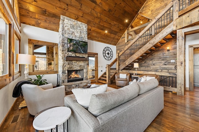 living room with a stone fireplace, wooden ceiling, dark wood-type flooring, high vaulted ceiling, and plenty of natural light