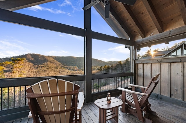 wooden deck featuring ceiling fan and a mountain view