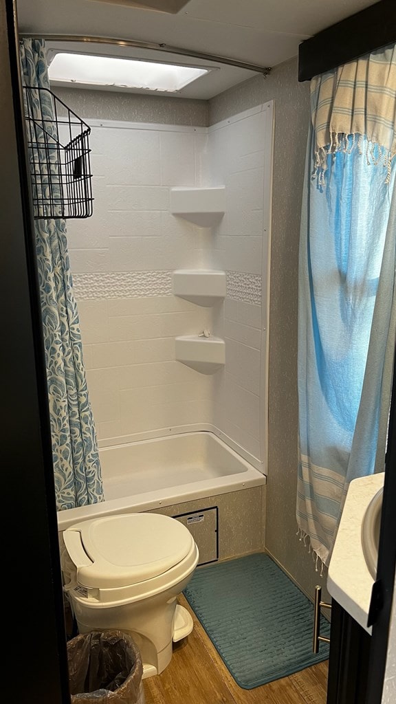 full bathroom with vanity, toilet, shower / bath combo, and wood finished floors