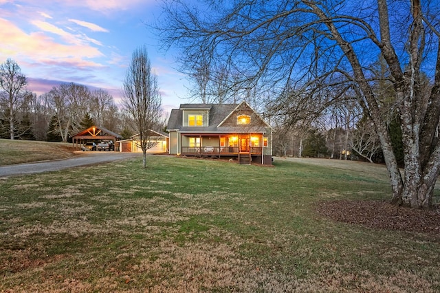 view of front facade with a garage, covered porch, and a front yard