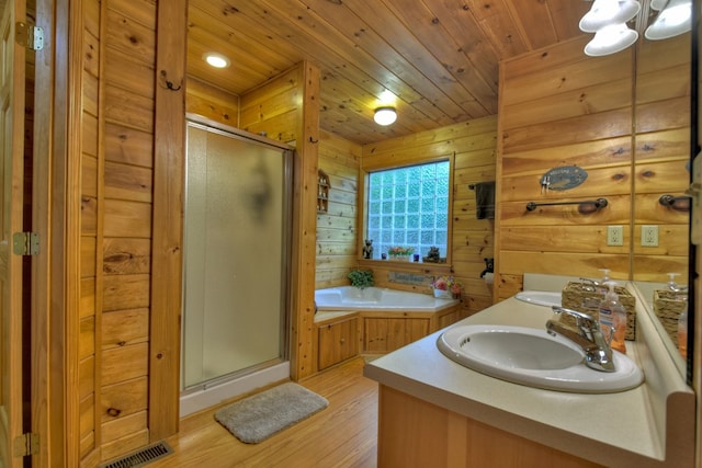 full bathroom featuring visible vents, wooden ceiling, a stall shower, a bath, and a sink