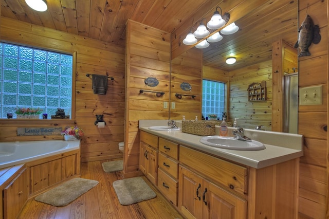 full bath with toilet, a sink, wood finished floors, wooden walls, and wood ceiling