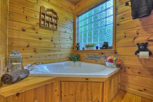 full bath with a bath and wooden walls