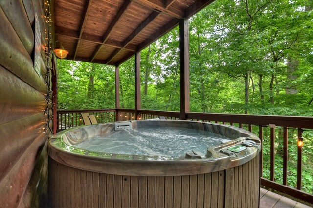 wooden deck featuring a hot tub