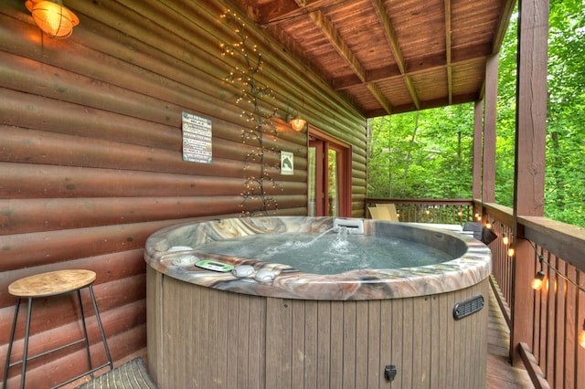 wooden deck featuring a hot tub