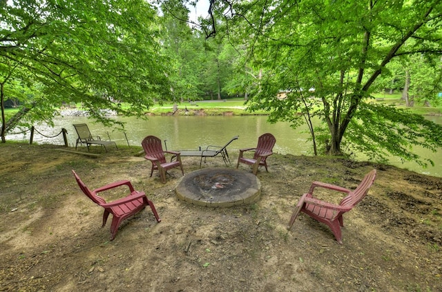 view of yard with a fire pit and a water view