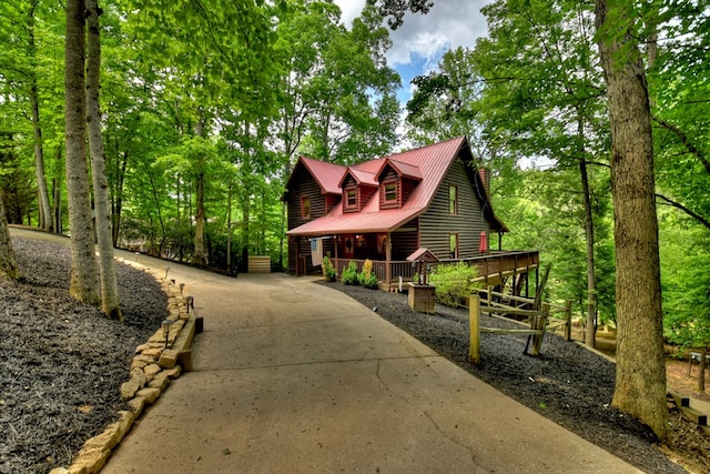 chalet / cabin featuring a deck and metal roof