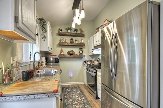 27 Ivy St, Ellijay, GA 30540 - kitchen with stainless steel appliances, open shelves, light wood-type flooring, under cabinet range hood, and white cabinetry