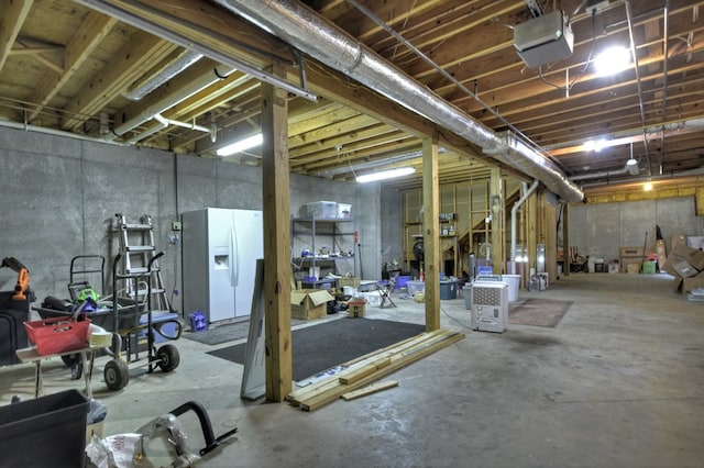 27 Ivy St, Ellijay, GA 30540 - unfinished below grade area with white fridge with ice dispenser