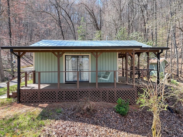 526 Garland Ridge Dr, Hayesville, NC 28904 - view of front of house with metal roof, a wooded view, and an outdoor structure