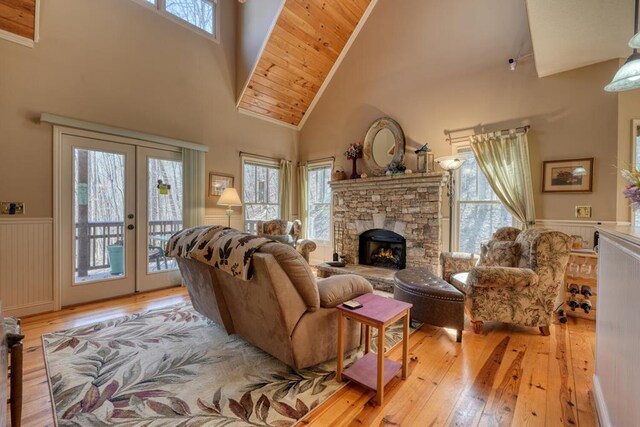 526 Garland Ridge Dr, Hayesville, NC 28904 - living room featuring wainscoting, light wood-style floors, french doors, and a healthy amount of sunlight