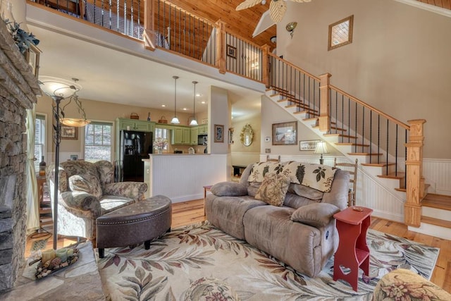 526 Garland Ridge Dr, Hayesville, NC 28904 - living area with a high ceiling, stairs, light wood-style flooring, and wainscoting