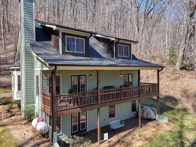 526 Garland Ridge Dr, Hayesville, NC 28904 - view of front of property featuring a chimney, a wooden deck, a forest view, and roof with shingles