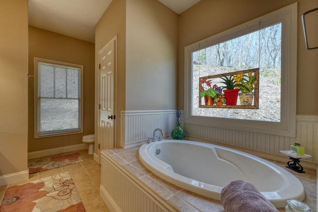 526 Garland Ridge Dr, Hayesville, NC 28904 - bathroom featuring a garden tub, toilet, tile patterned floors, and wainscoting