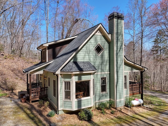 526 Garland Ridge Dr, Hayesville, NC 28904 - view of property exterior featuring a chimney and roof with shingles