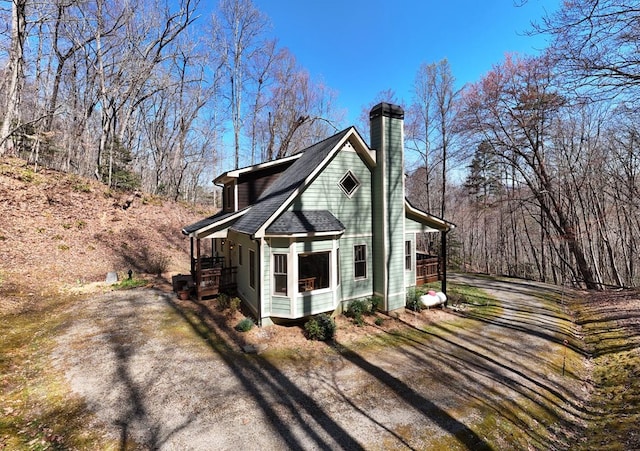 526 Garland Ridge Dr, Hayesville, NC 28904 - view of side of home with a chimney, a shingled roof, and a porch