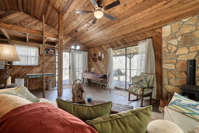 526 Garland Ridge Dr, Hayesville, NC 28904 - living room featuring vaulted ceiling, a wood stove, wooden ceiling, ceiling fan with notable chandelier, and wooden walls