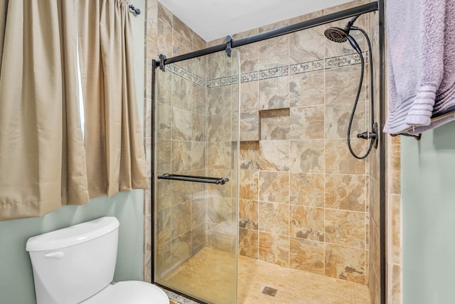 full bathroom featuring a shower stall and toilet