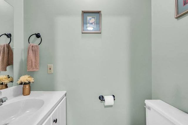 bathroom featuring toilet and vanity